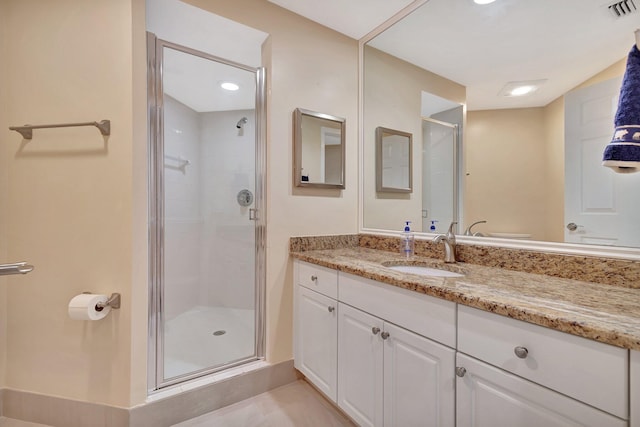 bathroom featuring tile patterned floors, vanity, and walk in shower