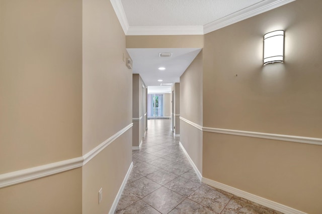 corridor featuring light tile patterned floors and crown molding