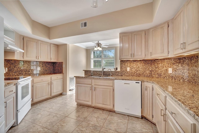 kitchen with tasteful backsplash, ceiling fan, sink, and white appliances