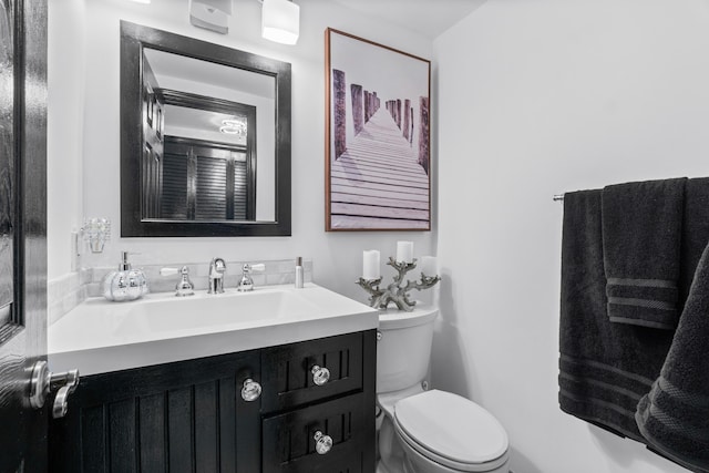 bathroom with toilet and vanity