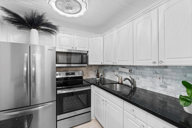 kitchen with stainless steel appliances, sink, and white cabinetry