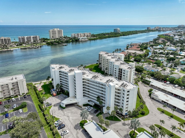 drone / aerial view featuring a city view and a water view