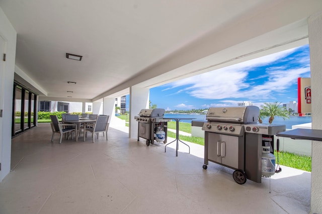 view of patio / terrace with a water view and a grill