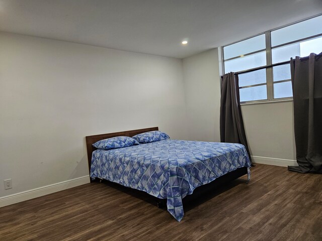 bedroom featuring dark wood-type flooring