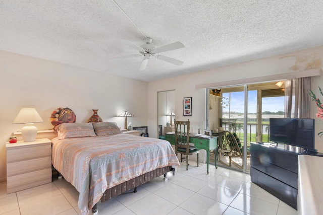 bedroom with a textured ceiling, a ceiling fan, light tile patterned floors, and access to outside
