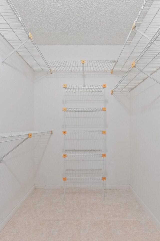 spacious closet featuring tile patterned floors