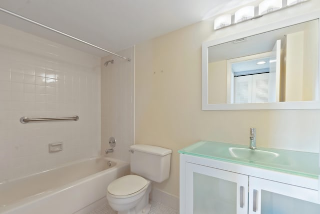 bathroom featuring vanity, toilet, baseboards, tub / shower combination, and tile patterned floors