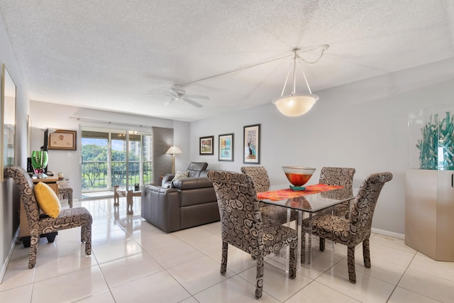 dining room featuring ceiling fan, a textured ceiling, and light tile patterned floors