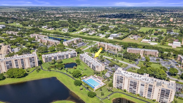 drone / aerial view featuring a water view and a view of city