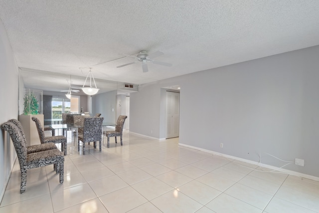 dining area featuring a ceiling fan, light tile patterned floors, a textured ceiling, and visible vents