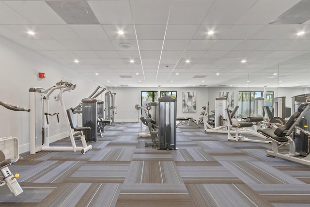 gym with baseboards, carpet floors, and a wealth of natural light