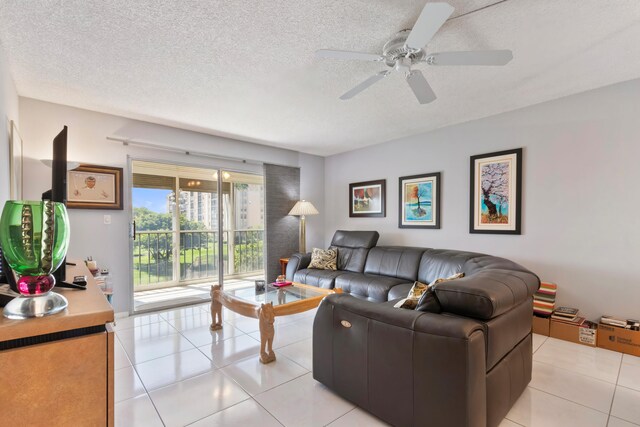 living room with ceiling fan and light tile patterned flooring