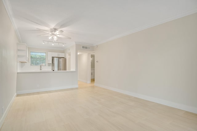 empty room with ceiling fan and ornamental molding