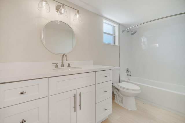 full bathroom with vanity, tiled shower / bath combo, and toilet