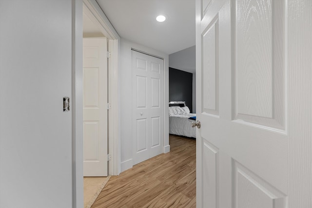 hallway with light hardwood / wood-style flooring