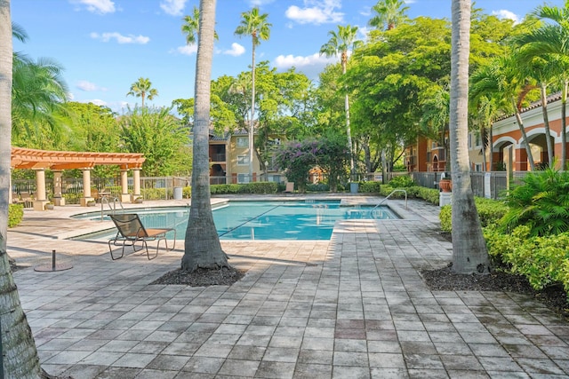 view of swimming pool with a pergola and a patio