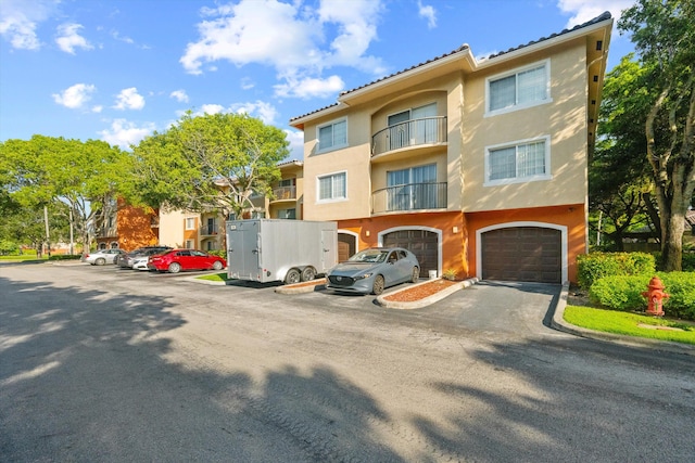 view of front of house with a balcony and a garage