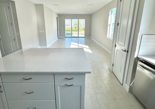 kitchen with gray cabinets, a center island, and dishwasher