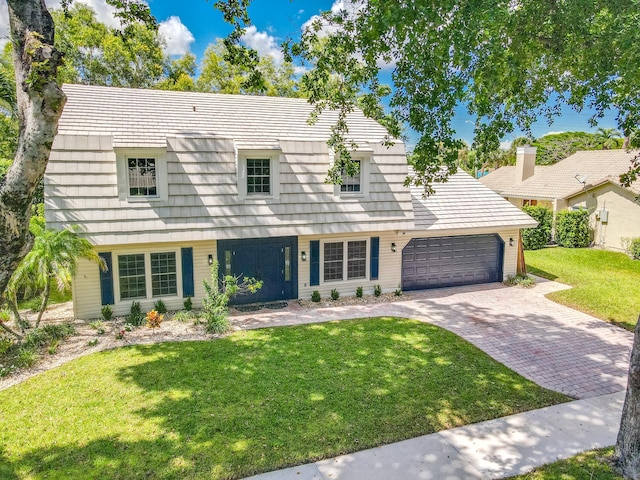 view of front of house with a garage and a front yard