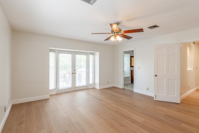 spare room with light hardwood / wood-style floors, ceiling fan, and french doors