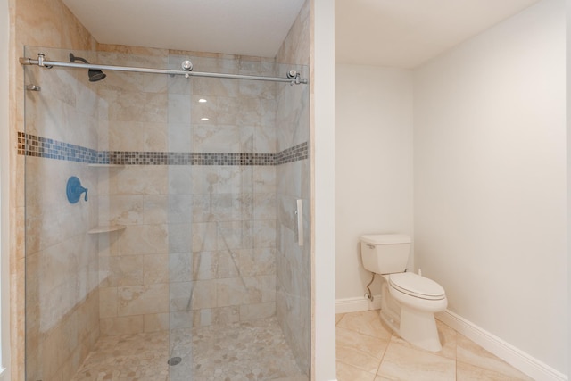 bathroom featuring a shower with shower door, toilet, and tile patterned floors