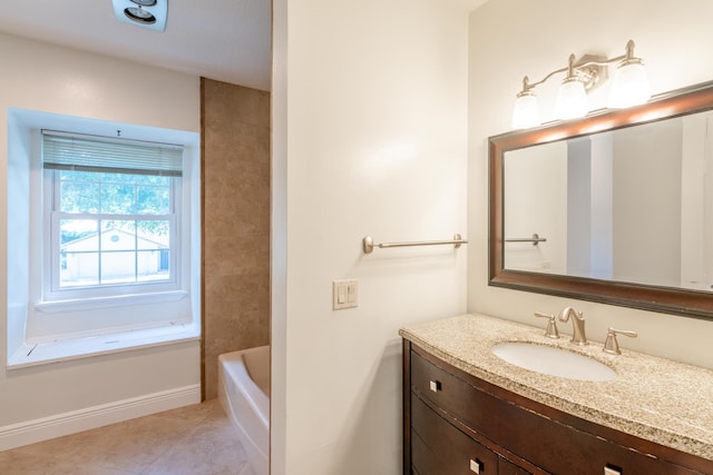 bathroom with tile patterned floors, vanity, and a bathtub