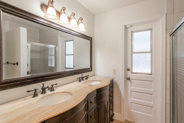 bathroom featuring an enclosed shower and vanity