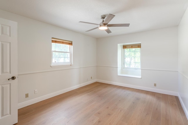 spare room with light hardwood / wood-style flooring and ceiling fan