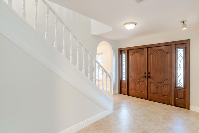 entryway with light tile patterned floors