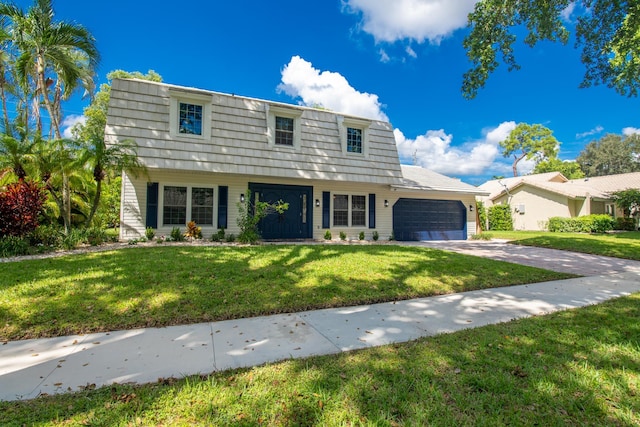 view of front of property with a garage and a front lawn