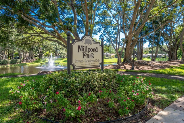 community / neighborhood sign featuring a water view