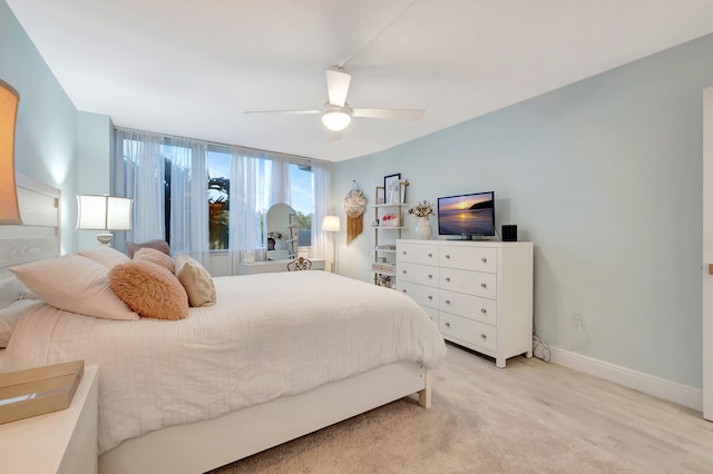 bedroom with light wood-type flooring and ceiling fan