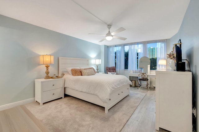 bedroom featuring ceiling fan and light wood-type flooring