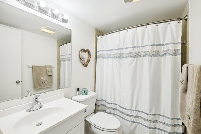 bathroom with vanity, toilet, and curtained shower