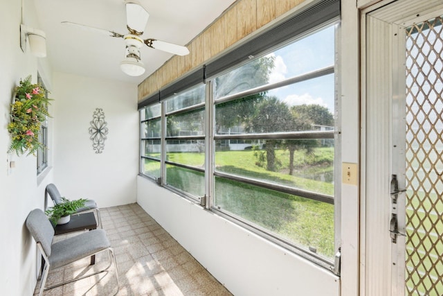 sunroom / solarium featuring a wealth of natural light and ceiling fan