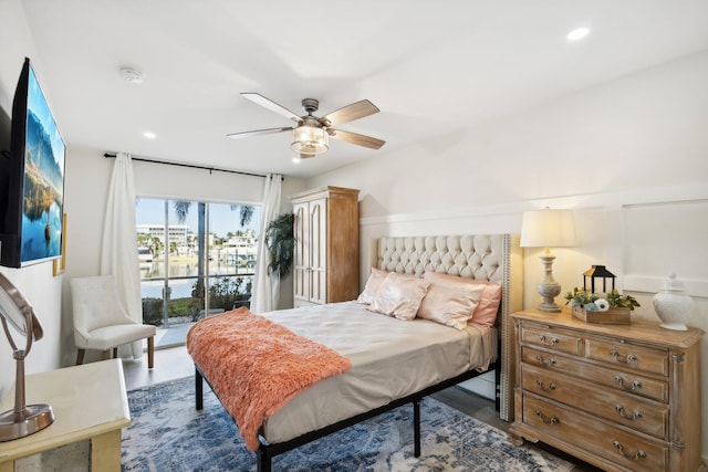 bedroom featuring ceiling fan, dark hardwood / wood-style floors, and access to outside