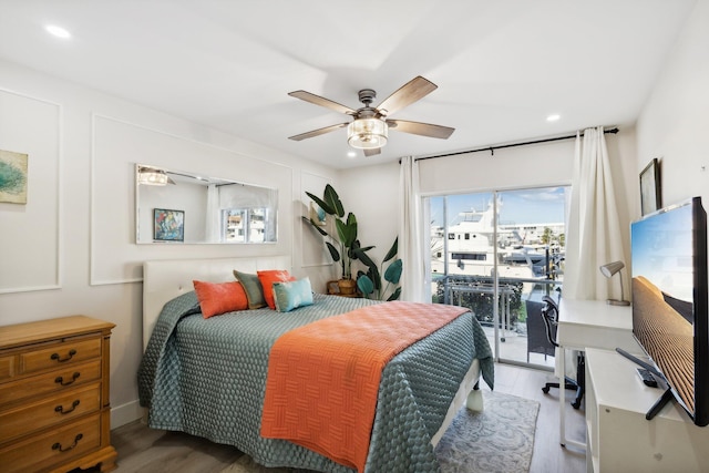 bedroom with wood-type flooring, access to outside, and ceiling fan