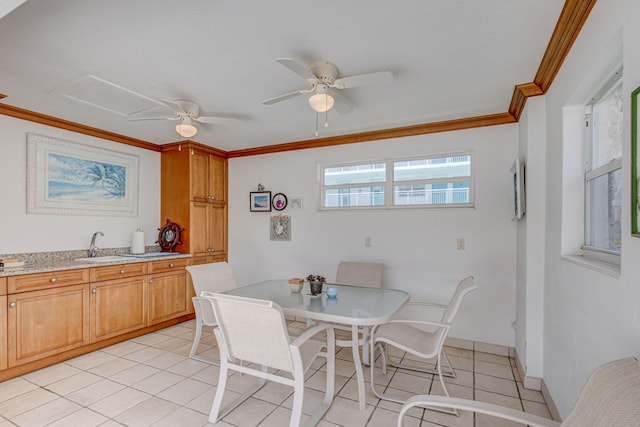 dining space featuring light tile patterned floors, crown molding, sink, and ceiling fan