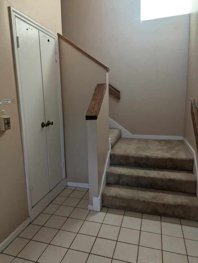 stairs featuring tile patterned flooring