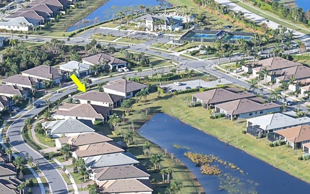 drone / aerial view featuring a residential view and a water view