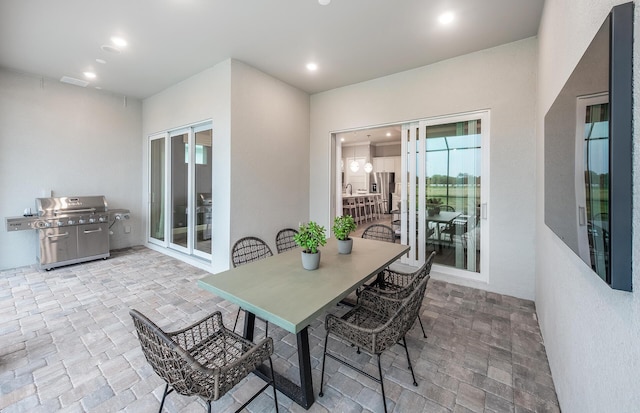 view of patio / terrace featuring outdoor dining area, visible vents, and grilling area