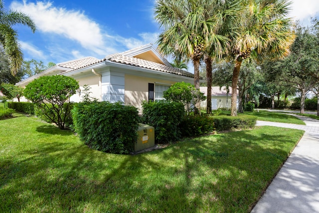 view of side of property with a yard