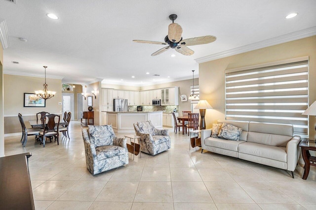 living room featuring ceiling fan with notable chandelier, ornamental molding, and light tile patterned floors