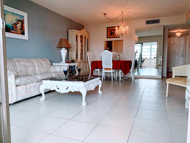 living room with a notable chandelier and light tile patterned floors