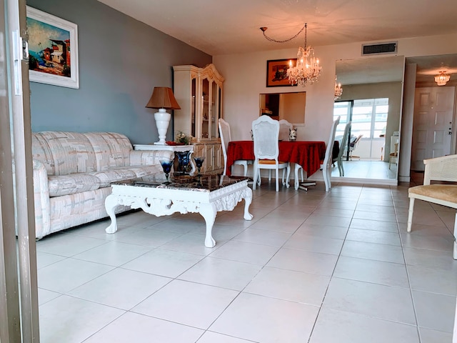 tiled living room with a notable chandelier