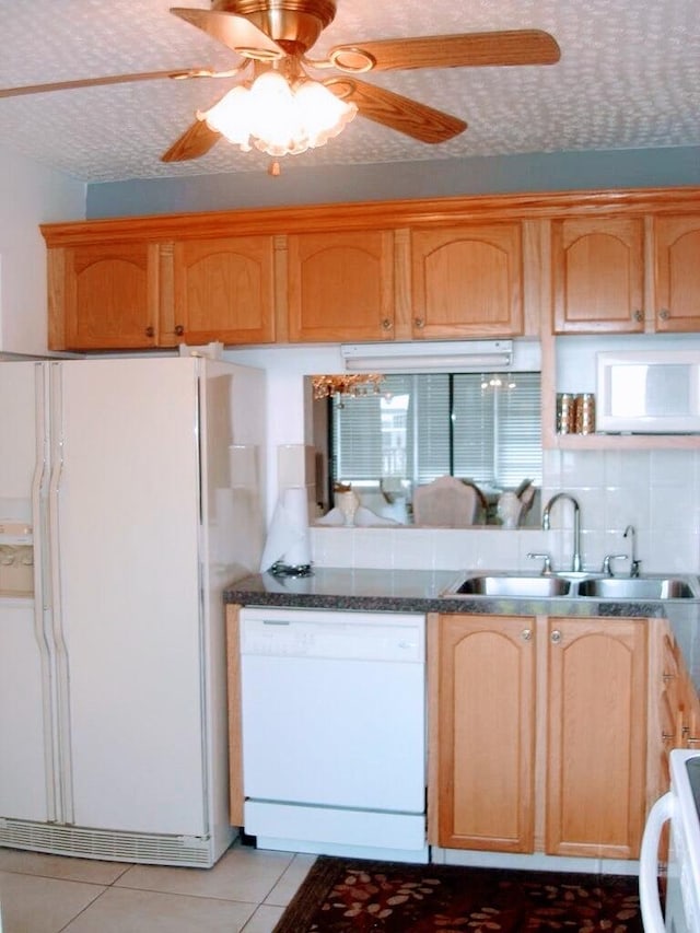 kitchen featuring ceiling fan, light tile patterned floors, a textured ceiling, sink, and white appliances