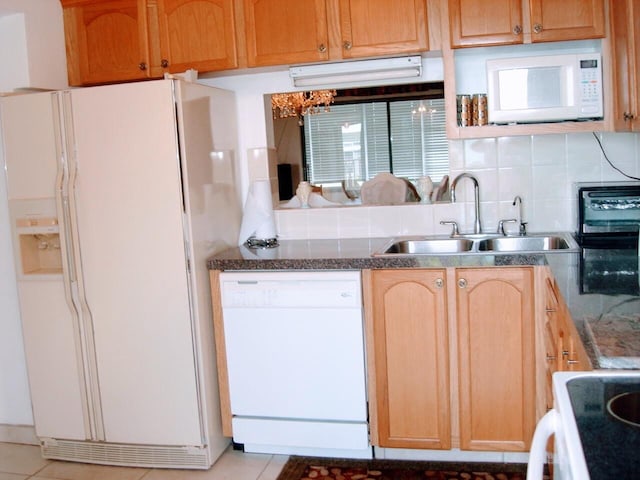 kitchen featuring white appliances, light tile patterned floors, tasteful backsplash, and sink