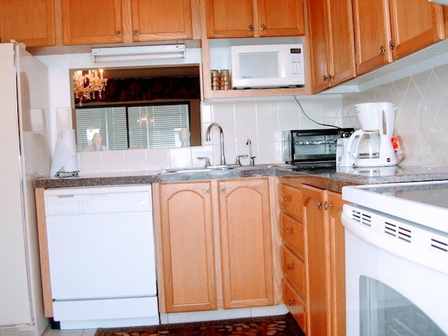 kitchen featuring tasteful backsplash, sink, and white appliances