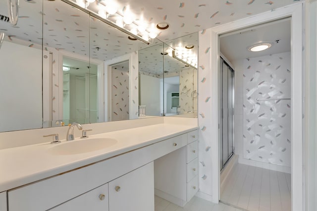 bathroom featuring vanity, tile patterned flooring, and a shower with door