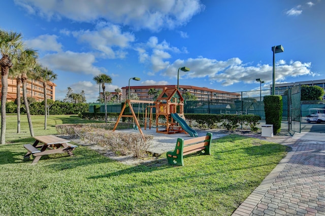 communal playground with fence and a lawn